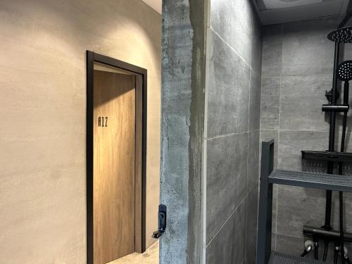 a wooden door in a room with a wall at hsueh_house in Yilan City