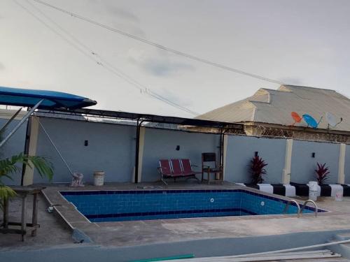 a house with a swimming pool with a roof at Meerah apartments & Hotels 