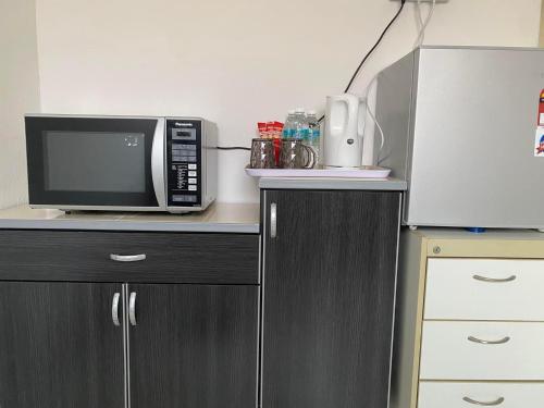 a microwave oven sitting on top of a counter at Cik Misi Homestay Jeniang in Sik