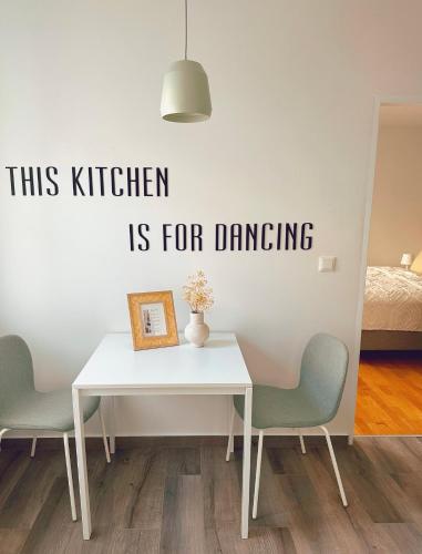 a dining room with a table and two chairs at Suites in Mödling in Mödling