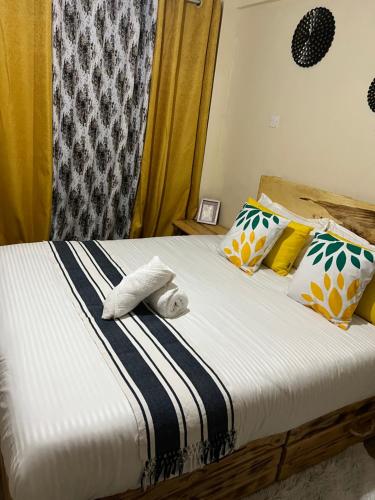 1 dormitorio con 1 cama con toallas en Cozy 1br apartment in King’ong’o-Nyeri en Nyeri