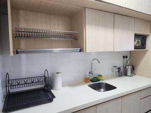 a kitchen with a sink and a counter top at SY@Tiara Homestay in Bangi