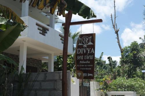 a sign for a restaurant in front of a building at Divya Sea View in Dodampahala East