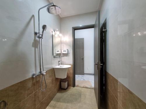 y baño con lavabo y ducha. en Linh's Home 101 Phòng riêng tiện nghi, en Tân Ðiền