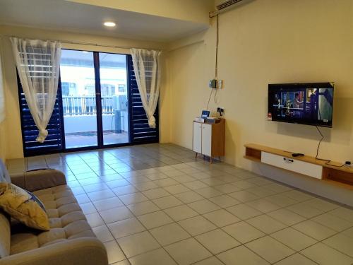 a living room with a couch and a tv at BS Home in Miri City - 3R2B House Pelita Commercial Centre in Miri