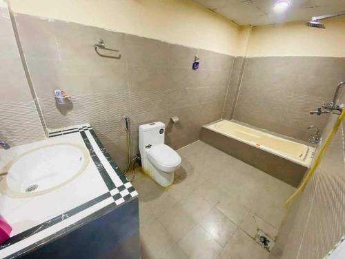 La salle de bains est pourvue d'un lavabo, de toilettes et d'une baignoire. dans l'établissement Shisha lounge bar and guest house, à Juribela