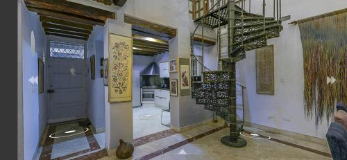 a hallway with a spiral staircase in a house at Luxury Large Apartment With Colonial Balcony in Cartagena de Indias