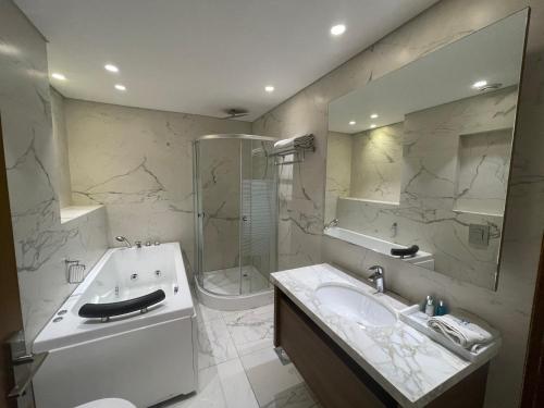 a bathroom with a sink and a shower and a toilet at Heaven Prestige Hotel in Jounieh
