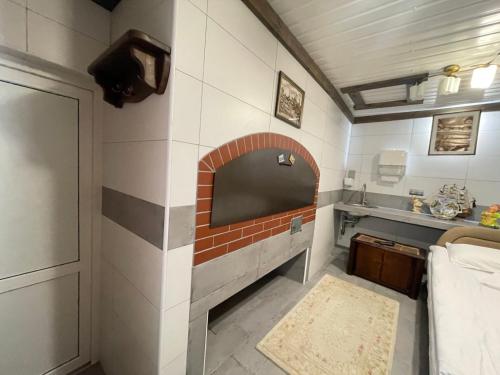 a kitchen with a brick fireplace in a room at Хостел 24 in Khmelnytskyi