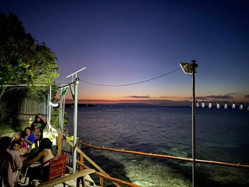 a group of people sitting on a boat looking at the water at JUSH NATIVE AND GLAMPING in Dauis