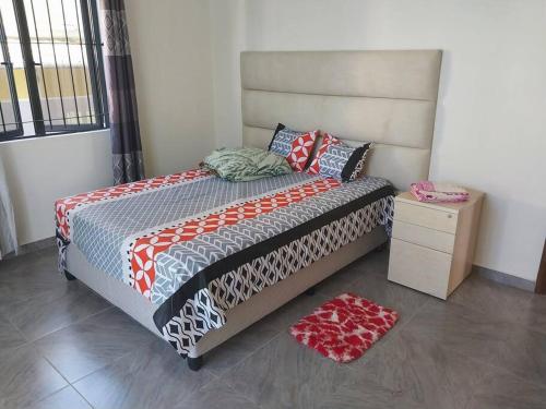 a bedroom with a bed and a nightstand and a bed sidx sidx at Villa Deux Bras in Deux Bras