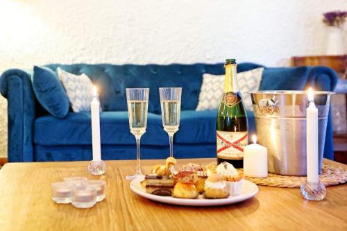 un tavolo con un piatto di cibo e due bicchieri di champagne di Casa Calina a Mauguio