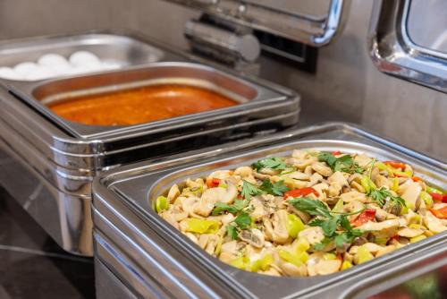 a dish of food in a container next to some sauce at Carina Gold Hotel And Restaurant in Istanbul