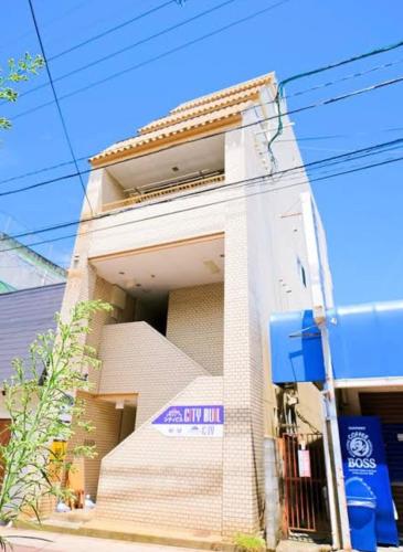 a building with a sign on the side of it at ゲストハウスシティ in Hitoyoshi
