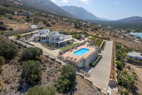 an aerial view of a house with a swimming pool at Tholos Boutique Houses in Kavoúsion
