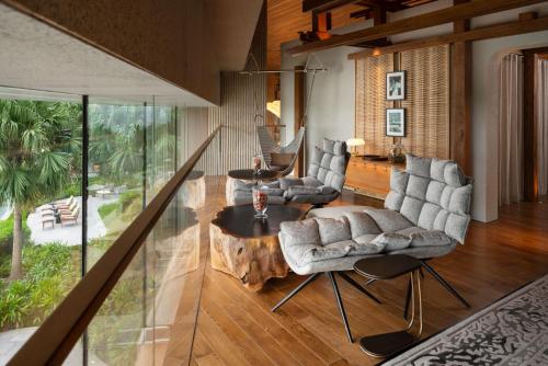 a living room with a table and chairs at New World Hoiana Beach Resort in Hoi An