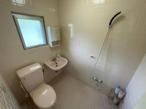 a bathroom with a toilet and a sink and a shower at NAGO Sakura Resort Inn - Vacation STAY 14445v in Nago