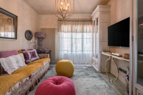 a living room with a couch and a tv at S Brigida Laurotino - Apartment With Pool Lamporecchio, Vinci Toscana in Lamporecchio