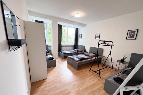a living room with two beds and a couch at Work & stay Langenfeld in Langenfeld