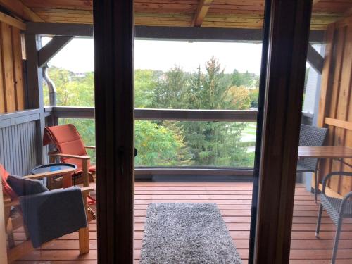 a screened in porch with a view of a patio at Pannonia Appartements in Bad Tatzmannsdorf