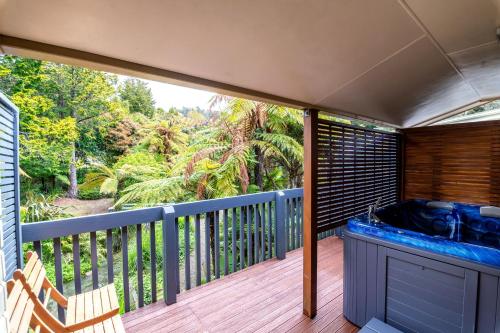 a hot tub on the deck of a house at Ripple Rotorua in Rotorua