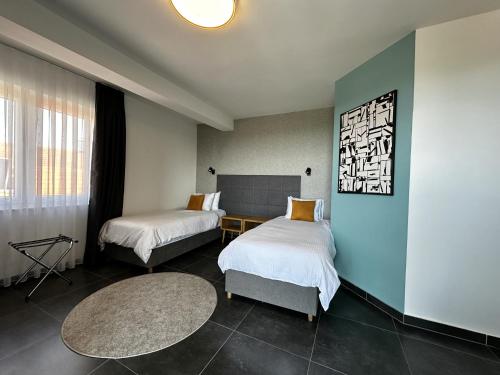 a hotel room with two beds and a table at La Vista Luxury Villa in Ohrid