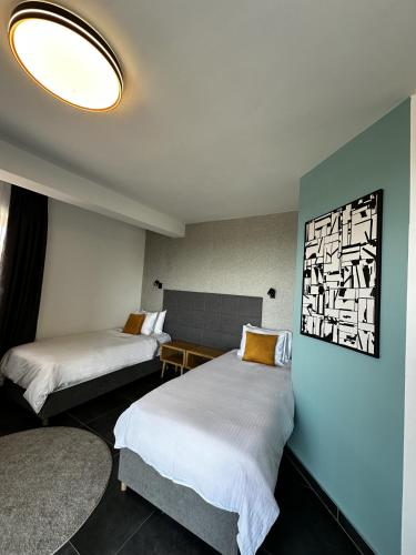 a hotel room with two beds and a window at La Vista Luxury Villa in Ohrid