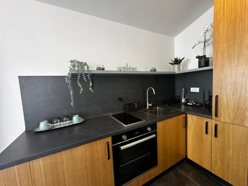 a kitchen with a sink and a black counter top at La Vista Luxury Villa in Ohrid