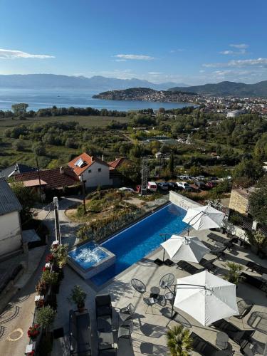 a view of a swimming pool with umbrellas at La Vista Luxury Villa in Ohrid