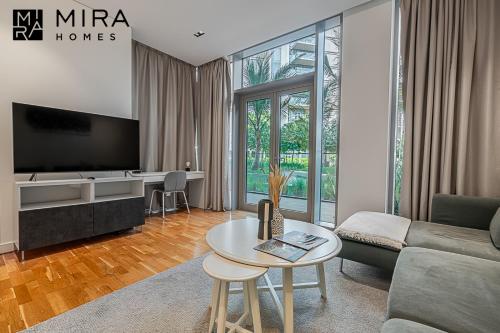 a living room with a couch and a table at Mira Holiday Homes - Serviced 1 bedroom in Bluewaters in Dubai