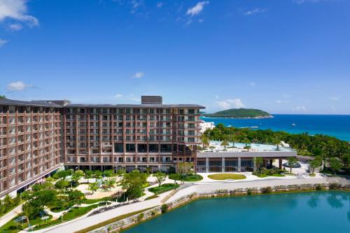 an aerial view of a resort with a pool at HUALUXE Hotels and Resorts Sanya Yalong Bay Resort in Sanya