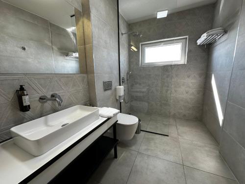 a bathroom with a tub and a sink and a toilet at La Vista Luxury Villa in Ohrid