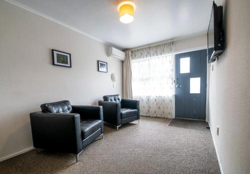 a waiting room with two chairs and a television at Ripple Rotorua in Rotorua
