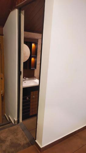 a bathroom with a sink and a mirror at Ambadi's villa -Lake view resort in Pallipuram