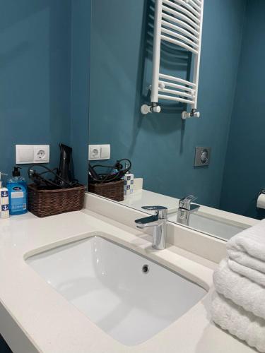 a bathroom with a white sink and a mirror at Ski in Ski out Slopeside apartments just 50 meters from the Gondola in New Gudauri in Gudauri