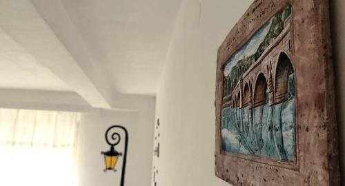 a painting on a wall in a room with a lamp at Center Apartment in Višegrad