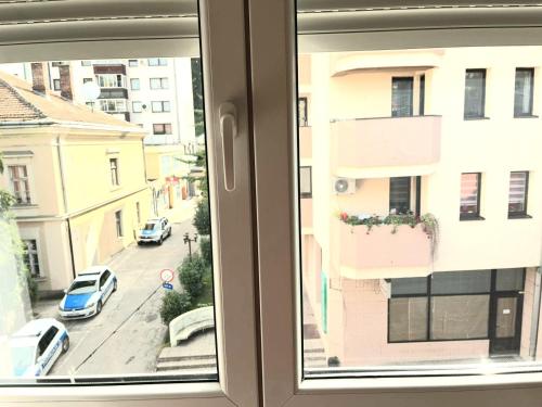 a window with a view of a city street at Center Apartment in Višegrad