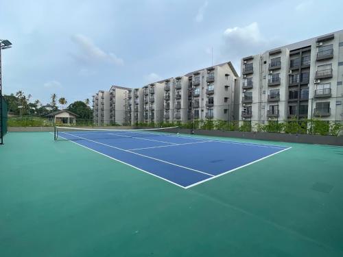 a tennis court in front of a apartment building at Elixia-Colombo,Malabe in Colombo