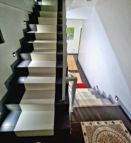 a black and white staircase in a house at Majestique Hotel Albay Bicol in Guinobatan