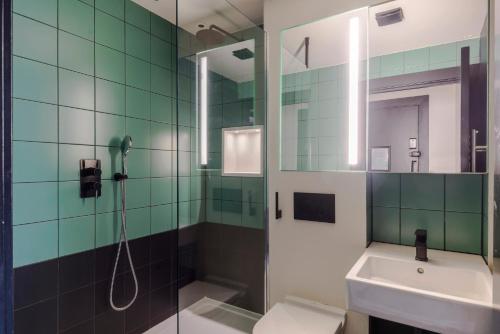 a bathroom with a shower and a sink and a toilet at The Sassy - Soho - by Frankie Says in London