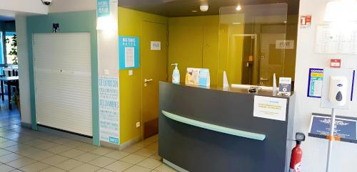a bathroom with a counter and a sink in a store at Kyriad Direct Poitiers - Gare du Futuroscope in Chasseneuil-du-Poitou