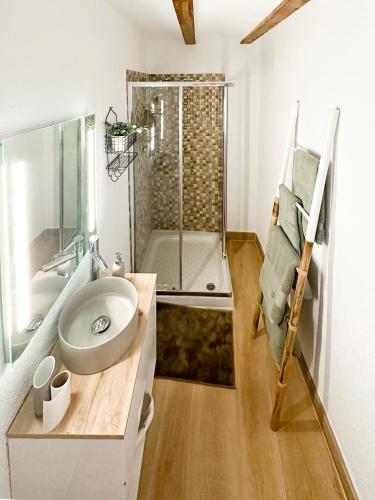 a bathroom with a sink and a glass shower at Casa Cueva Luna in Orce