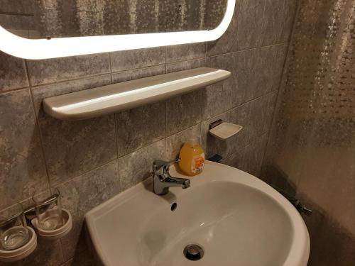 a bathroom sink with a bottle of soap on it at Mountain chalet in Mayrhofen