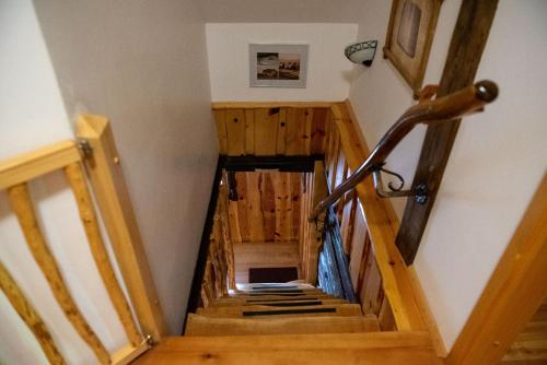 a wooden staircase in a house with a bike at Počitniška hiša Koča Dobnik in Lovrenc na Pohorju