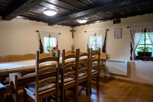 a dining room with a long table and chairs at Počitniška hiša Koča Dobnik in Lovrenc na Pohorju