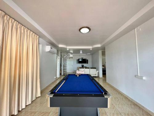 a room with a pool table in the middle of it at Sealife6 Beach Pool villa in Ban Nong Si Tong