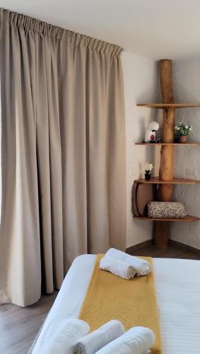 a bed with two pillows on it in a room at Hotel Rural los Caracoles in Frigiliana