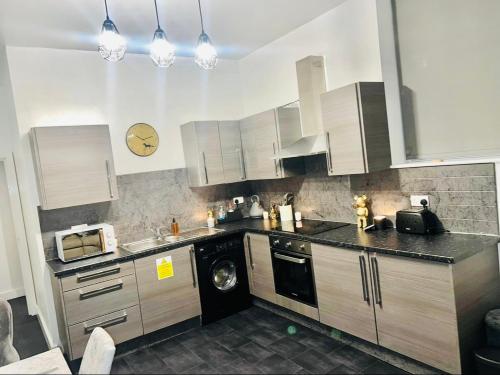 a kitchen with a washer and a washing machine at Heart of Sheffield in Sheffield
