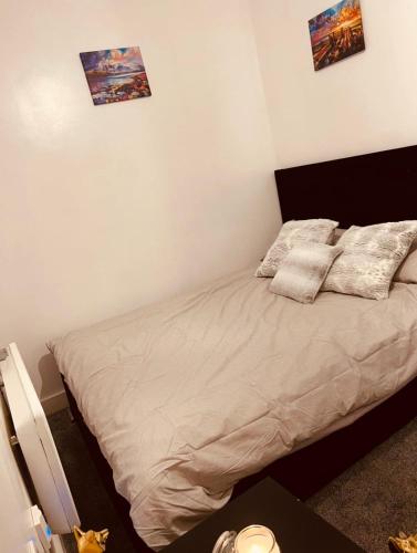a bed in a bedroom with two pillows on it at Heart of Sheffield in Sheffield