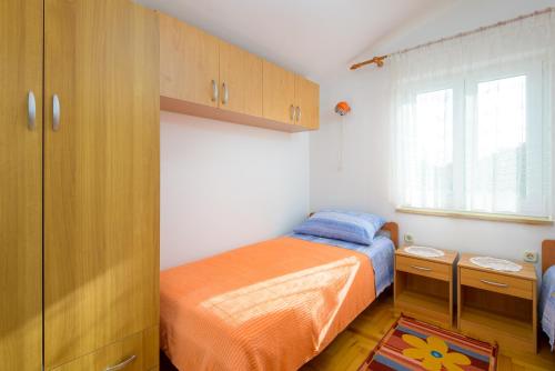 a small bedroom with a bed and a window at Villa Ana - Peaceful Location in Marčana